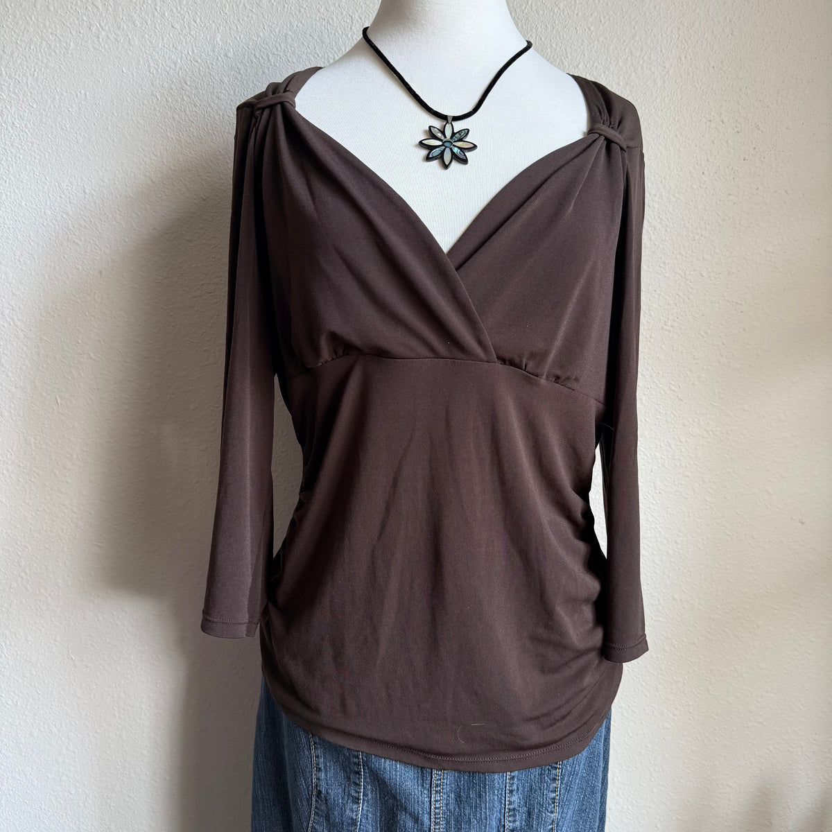 April’s brown sleeved top