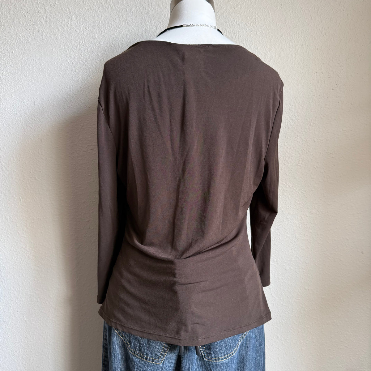 April’s brown sleeved top