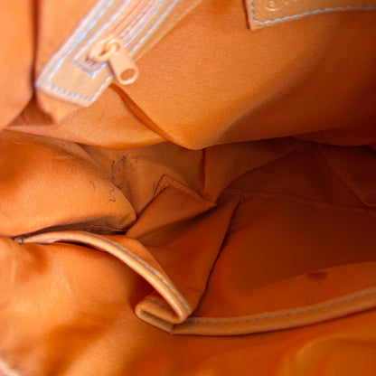 Carly’s orange shoulder bag