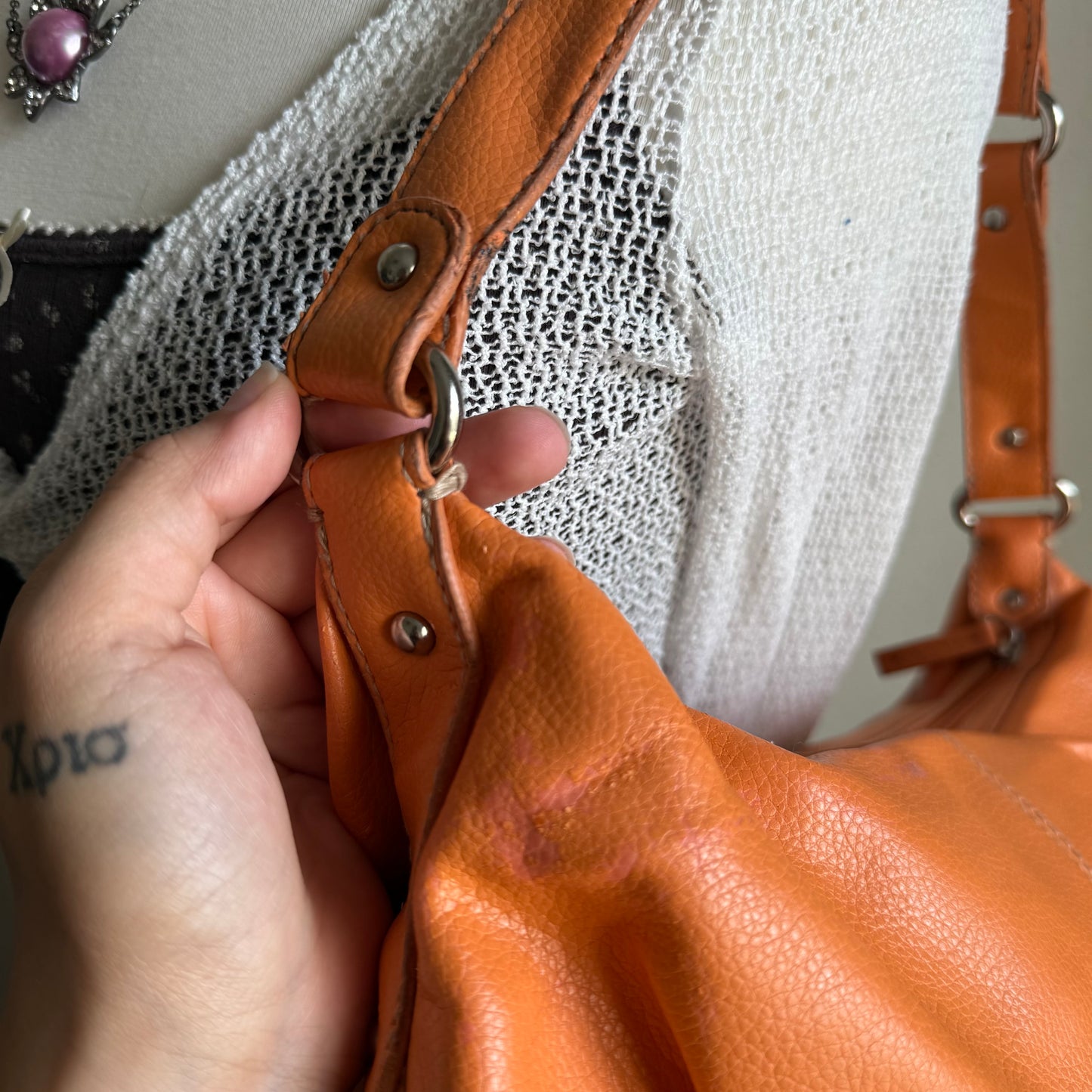 Carly’s orange shoulder bag