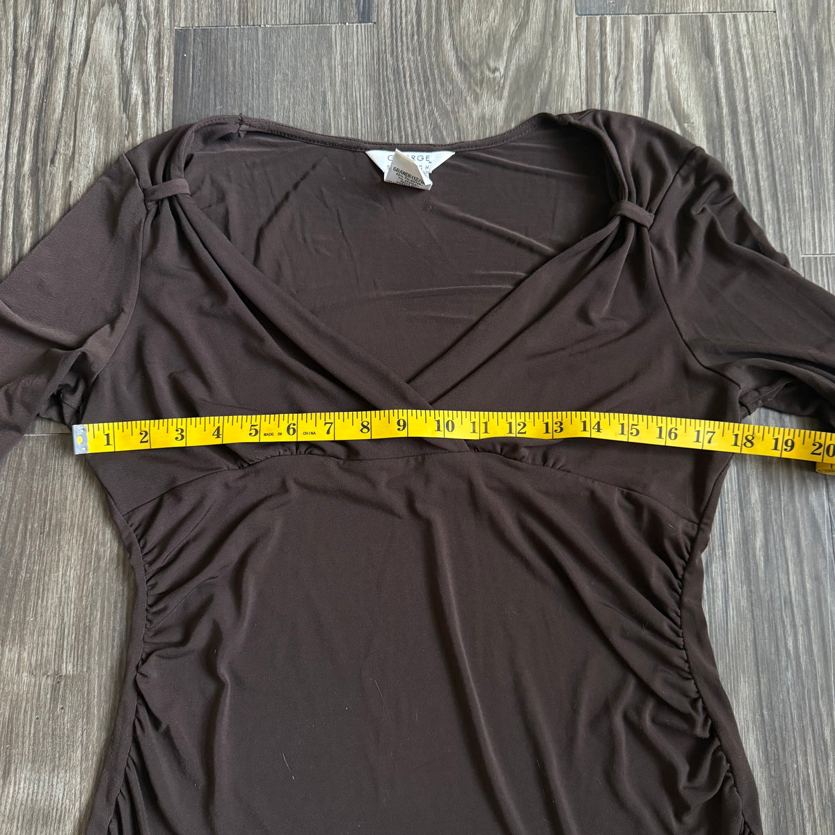 April’s brown sleeved top