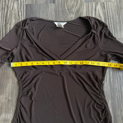 April’s brown sleeved top
