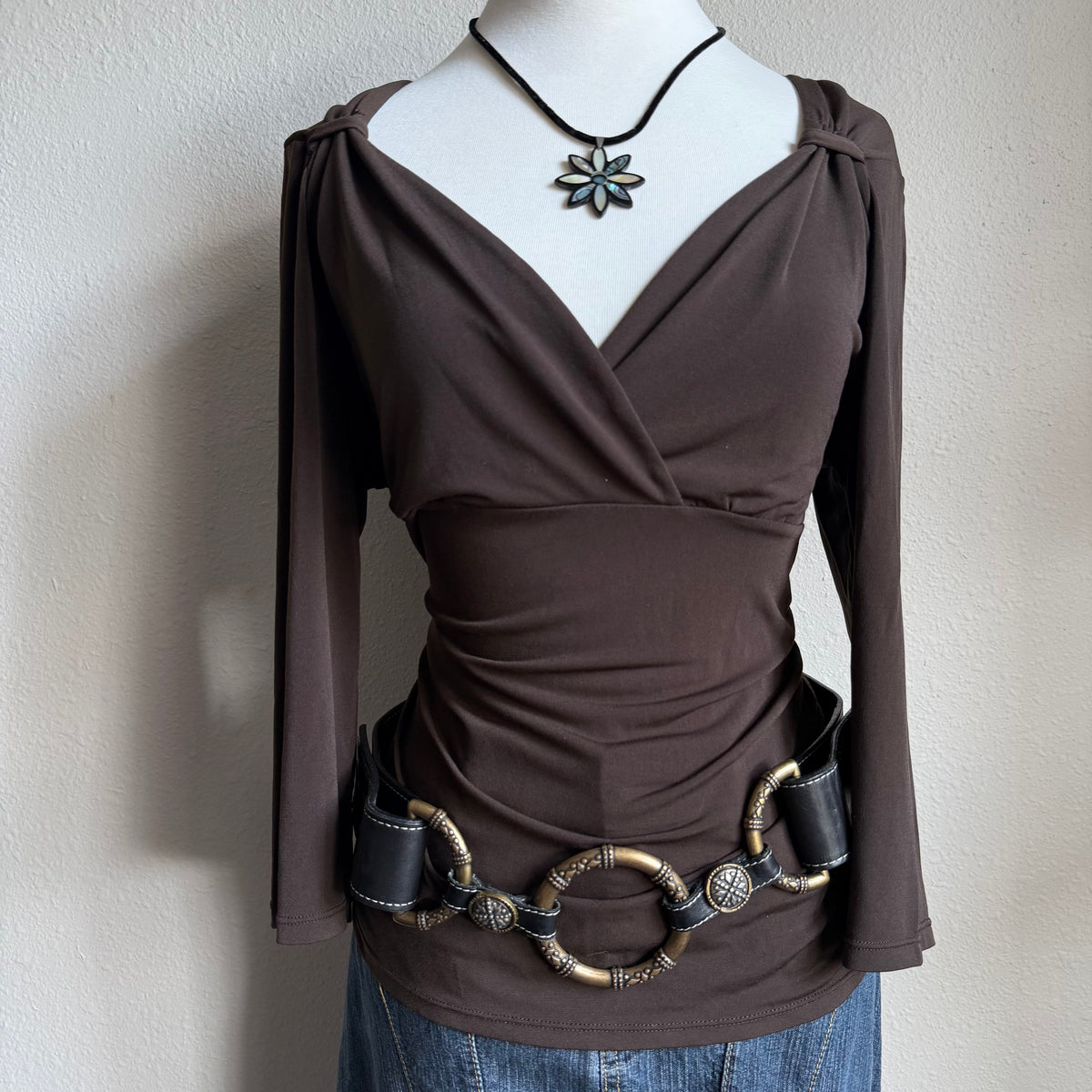 April’s brown sleeved top