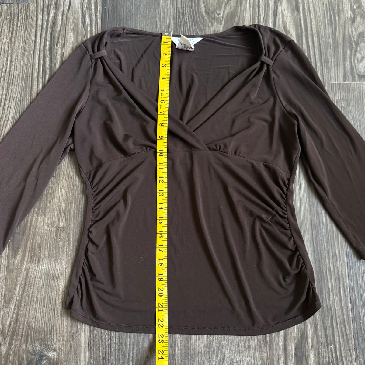 April’s brown sleeved top