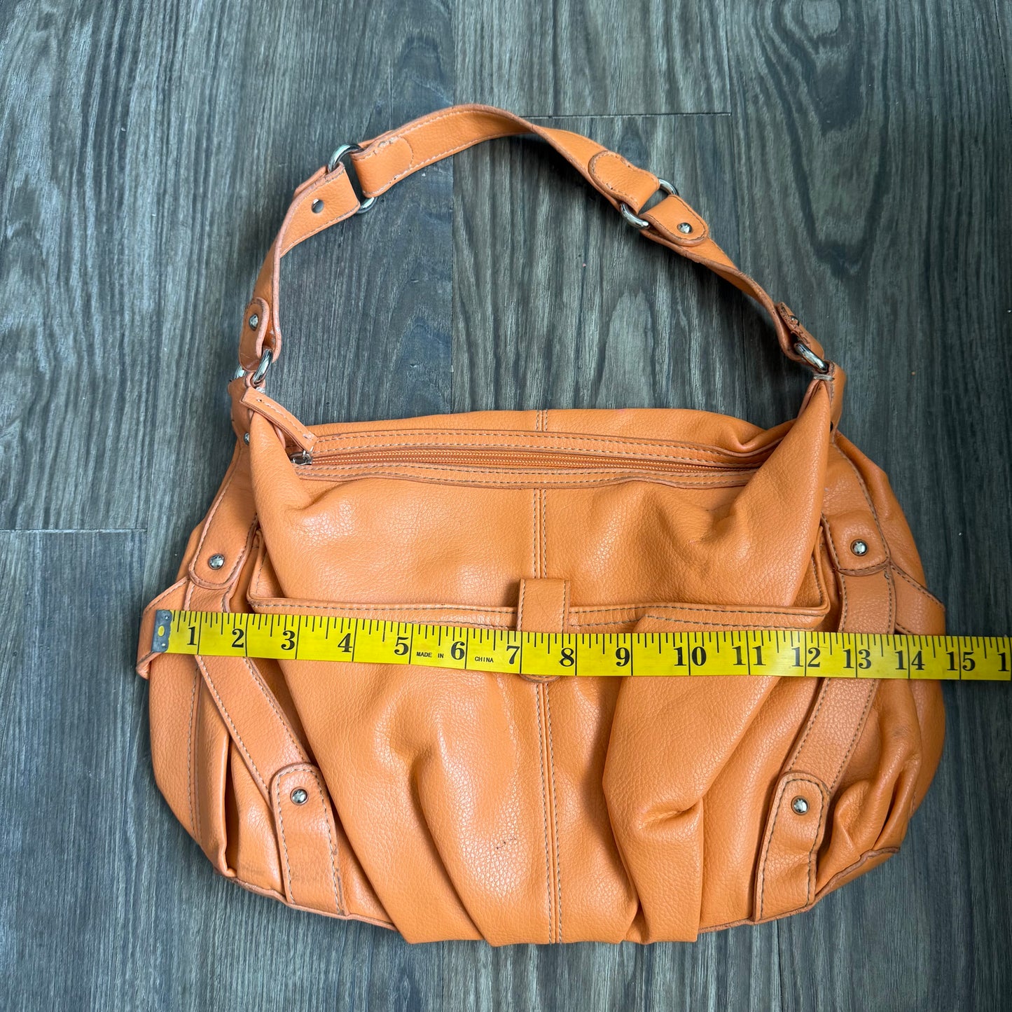 Carly’s orange shoulder bag