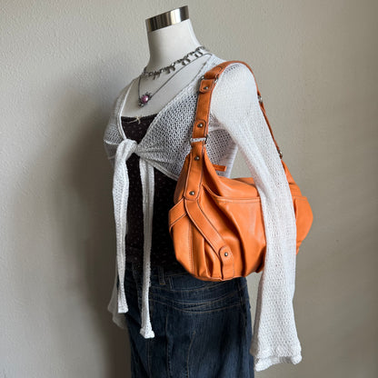 Carly’s orange shoulder bag