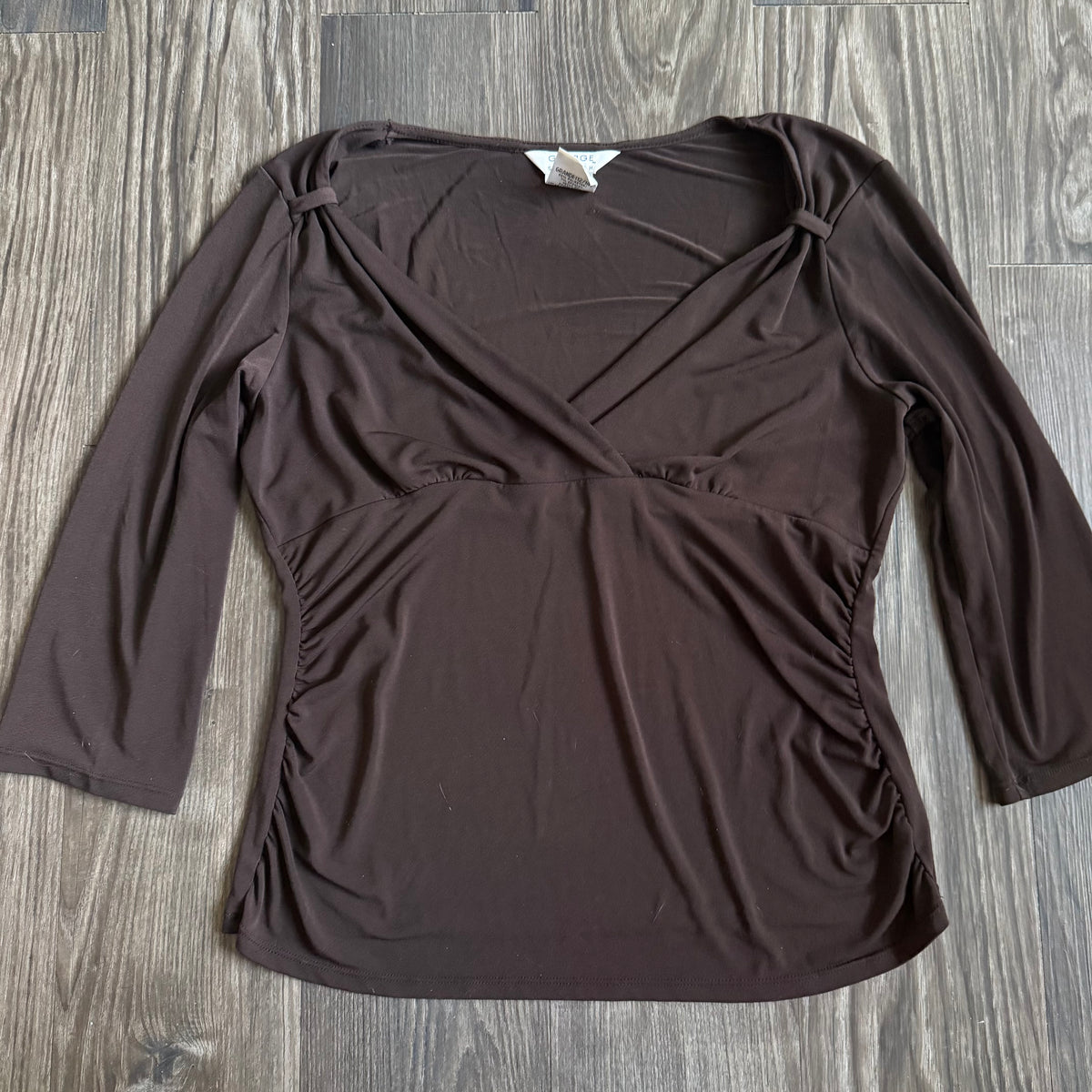 April’s brown sleeved top