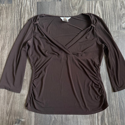 April’s brown sleeved top