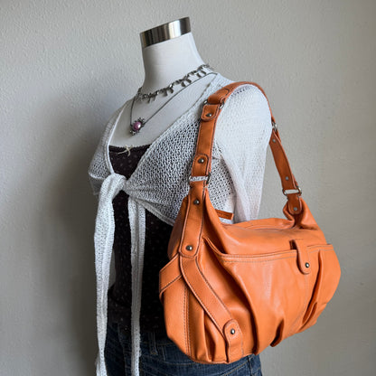 Carly’s orange shoulder bag
