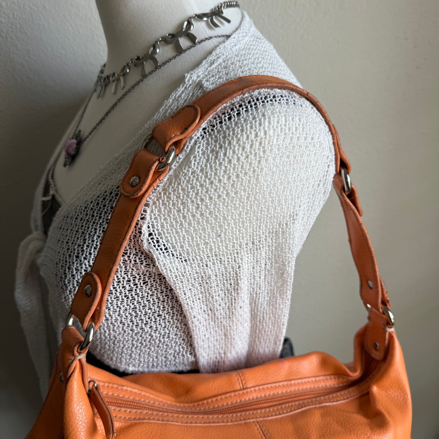 Carly’s orange shoulder bag